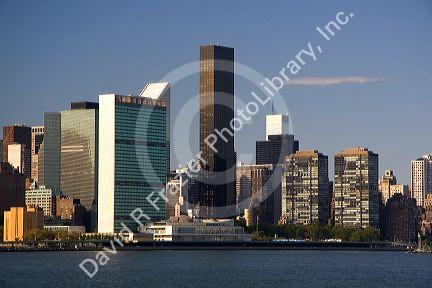 Green fronted United NAtions building and skyscrapers in New York City, New York, USA.