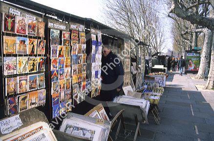 Sidewalk art seller along the Seine River in Paris, France.