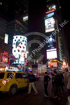 People hiring a cab in Times Square at night, Manhattan, New York City, New York, USA.