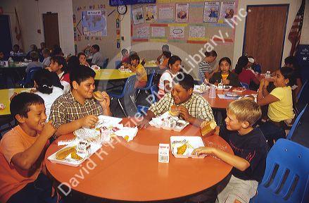 Multi ethnic children eating a school lunch in Florida.