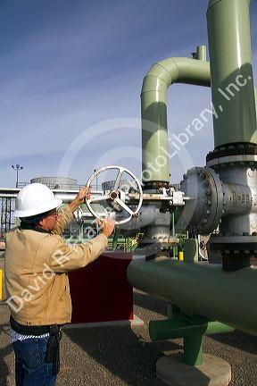 Operator turning a valve at a geothermal power plant in Malta, Idaho, USA. MR