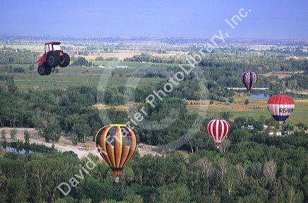 Hot air balloons floating over rural Idaho.