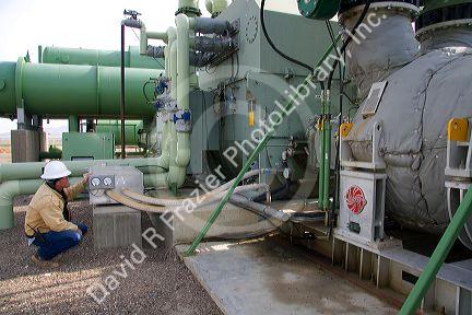 Operator checking the workings of a geothermal power plant in Malad, Idaho, USA. MR