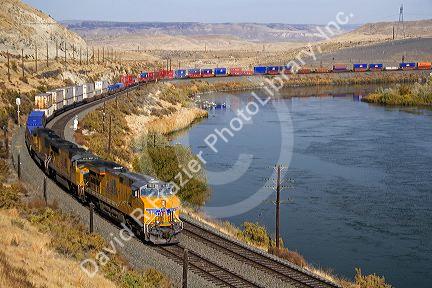 Union Pacific intermodal container train traveling along the Snake River in Elmore County, Idaho, USA.