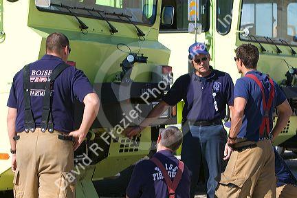 Firefighters taking direction from a training officer at an airport training facility in Boise, Idaho, USA.