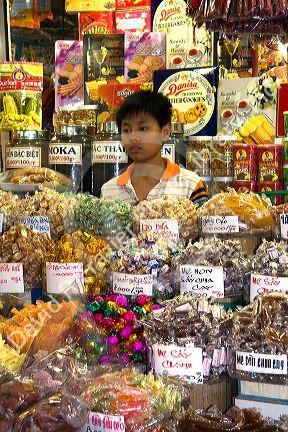 Young Vietnamese boy selling treats in the Ben Thanh Market located in Ho Chi Minh City, Vietnam.