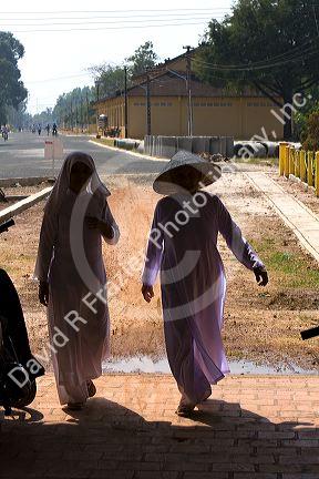 Caodaiists entering the Cao Dai Tay Ninh Holy See in Tay Ninh, Vietnam.