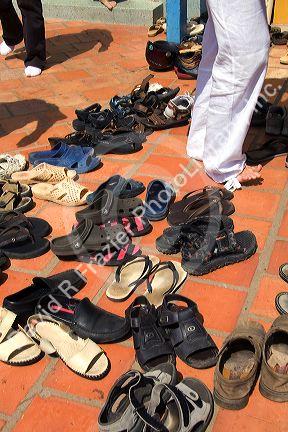 Shoes being removed to enter the Cao Dai Tay Ninh Holy See in Tay Ninh, Vietnam.