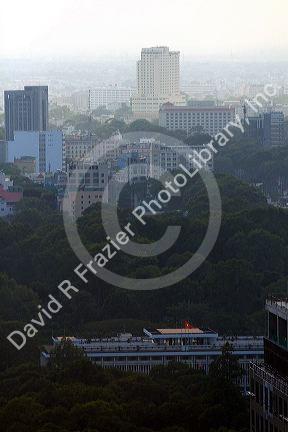 Cityscape views of a smoggy Ho Chi Minh City and top of Reunification Palace from atop the Saigon Trade Center skyscraper, Vietnam.