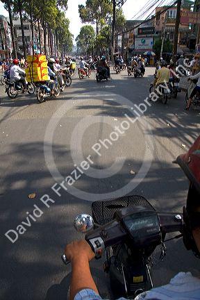 Vietnamese people ride motorbikes in Ho Chi Minh City, Vietnam.