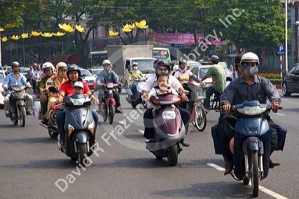 Vietnamese people ride motorbikes in Ho Chi Minh City, Vietnam.