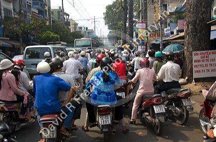 Vietnamese people ride motorbikes in Ho Chi Minh City, Vietnam.