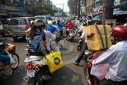 Vietnamese people ride motorbikes in Ho Chi Minh City, Vietnam.