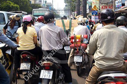 Vietnamese people ride motorbikes in Ho Chi Minh City, Vietnam.