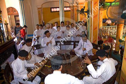 Musicians play music during a Cao Dai ceremony inside the Tay Ninh Holy See in Tay Ninh, Vietnam.
