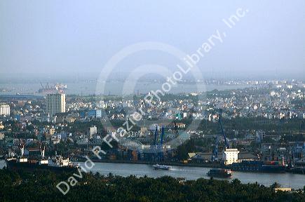 Cityscape view of a smoggy Ho Chi Minh City and Saigon River from atop the Saigon Trade Center skyscraper, Vietnam.