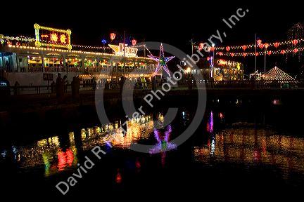 Floating restaurants on the Saigon River with lights at night in Ho Chi Minh City, Vietnam.