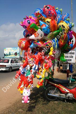 Vendor selling balloons along side the road in Dong Ha, Vietnam.