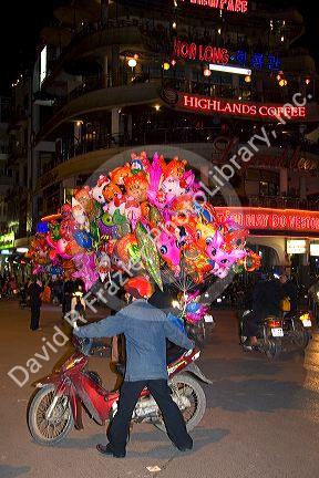 Street vendors selling colorful balloons for Tet in Hanoi, Vietnam.