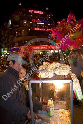 Street vendor selling popcorn during Tet in Hanoi, Vietnam.