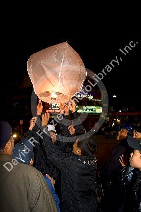 Vietnamese people celebrate Tet by releasing Sky Lanterns in Hanoi, Vietnam.