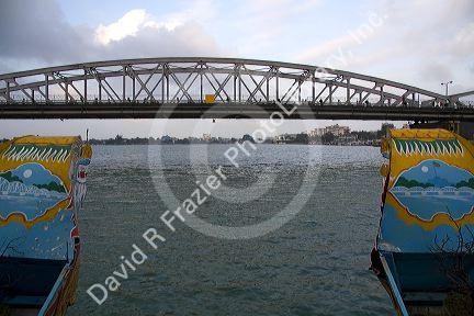Trang Tien Brige spanning the Perfume River as seen from a tourist Dragon Boat at Hue, Vietnam.