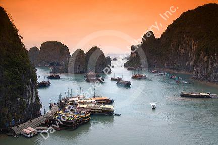 Scenic views of limestone karsts and tourist boats in Ha Long Bay, Vietnam.