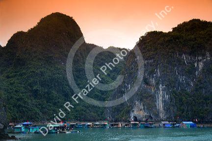 Scenic views of limestone karsts and tourist boats in Ha Long Bay, Vietnam.