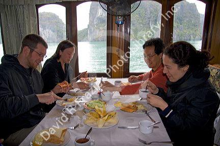 Tourists dine on a boat in Ha Long Bay, Vietnam.