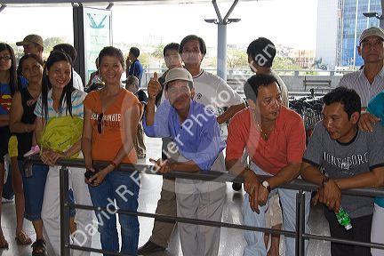 People waiting to greet passengers arriving at the Tan Son Nhat International Airport in Ho Chi Minh City, Vietnam.