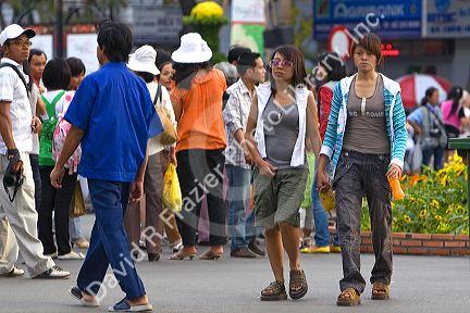 Vietnamese girls hold hands as a cultural jesture in Ho Chi Minh City, Vietnam.