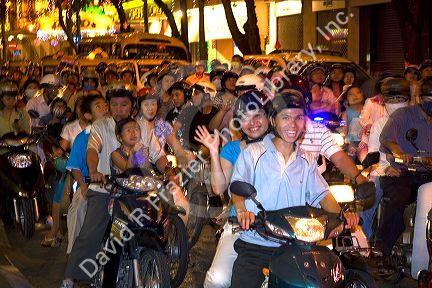 Vietnamese people ride motorbikes on Dong Khoi street during the last night of Tet Lunar New Year celebrations in Ho Chi Minh City, Vietnam.
