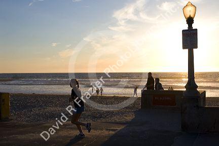 Jogger at sunset on Mission Beach in San Diego, Southern California, USA.