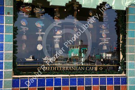Reflection of harbor in Mediterranean Cafe window in the town of Avalon on Catalina Island, California, USA.
