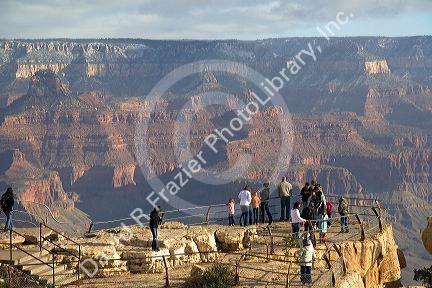 Tourists view the South Rim of the Grand Canyon, Arizona, USA.