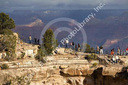 Tourists view the South Rim of the Grand Canyon, Arizona, USA.