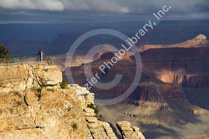 Tourists view the South Rim of the Grand Canyon, Arizona, USA.