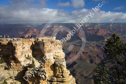 Tourists view the South Rim of the Grand Canyon, Arizona, USA.