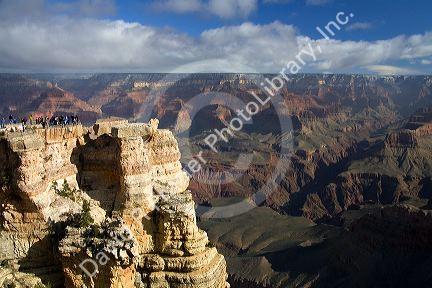 Tourists view the South Rim of the Grand Canyon, Arizona, USA.