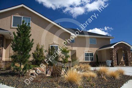 Xeriscaping using rock and native grass to conserve water at a residential home in Boise, Idaho, USA.