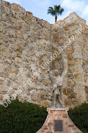 Statue in front of the Great Stone Church at Mission San Juan Capistrano, California, USA.