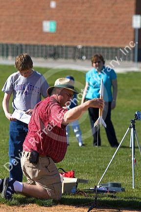 Father and son prepare to launch a model rocket for science education in Boise, Idaho.