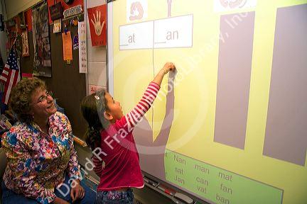 Kindergarten students use an interactive whiteboard in the classroom of a public school in Boise, Idaho, USA. MR