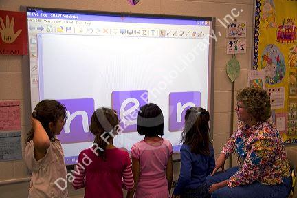 Kindergarten students use an interactive whiteboard in the classroom of a public school in Boise, Idaho, USA. MR