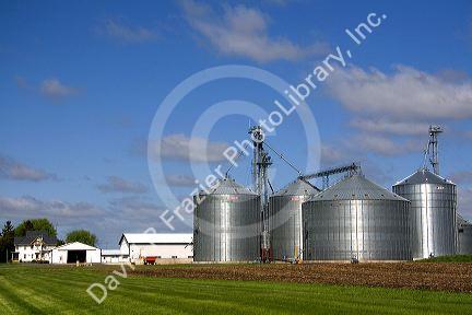 Metal grain storage bins on a farm in Sauk County, Wisconsin, USA.