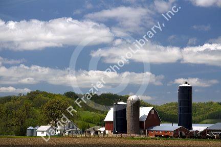 Red barn and grain silos on a farm in Manitowoc County, Wisconsin, USA.