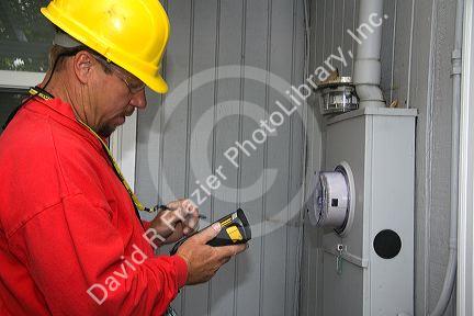 Idaho Power utility worker installing a new digital electric meter at a residential home in Boise, Idaho, USA.