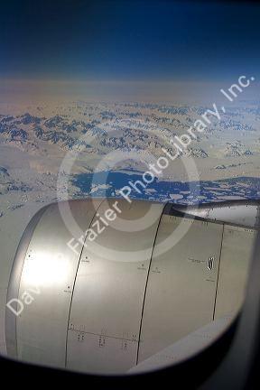 Aerial view of the glaciers and icebergs of Greenland from the window of an Airbus 330 passenger jet airliner.