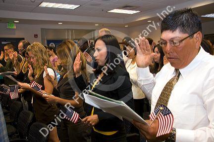 New United States citizens raise their right hand for citizenship oath ceremony in Idaho, USA.