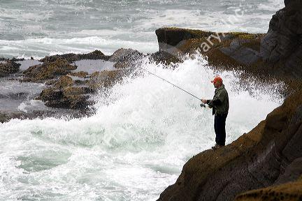 Fisherman at Boiler Bay on the Pacific Ocean near Depot Bay, Oregon, USA.